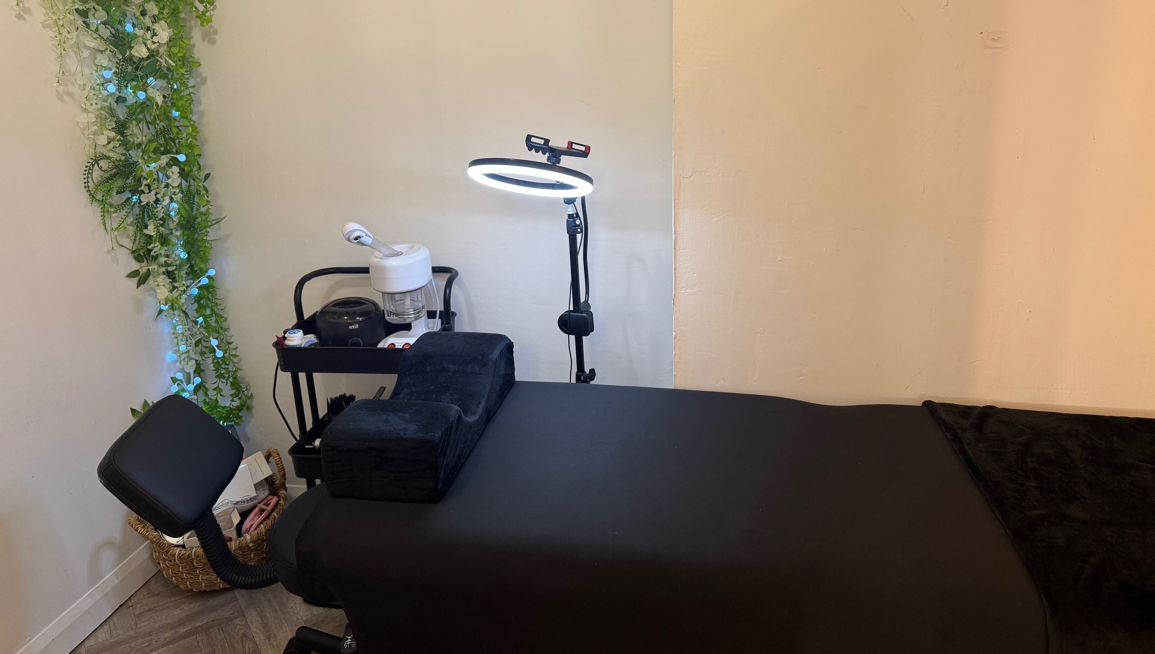 Relaxing treatment room at By Alicia - Hair and Beauty, Ponteland, England, GB with lush greenery decor.