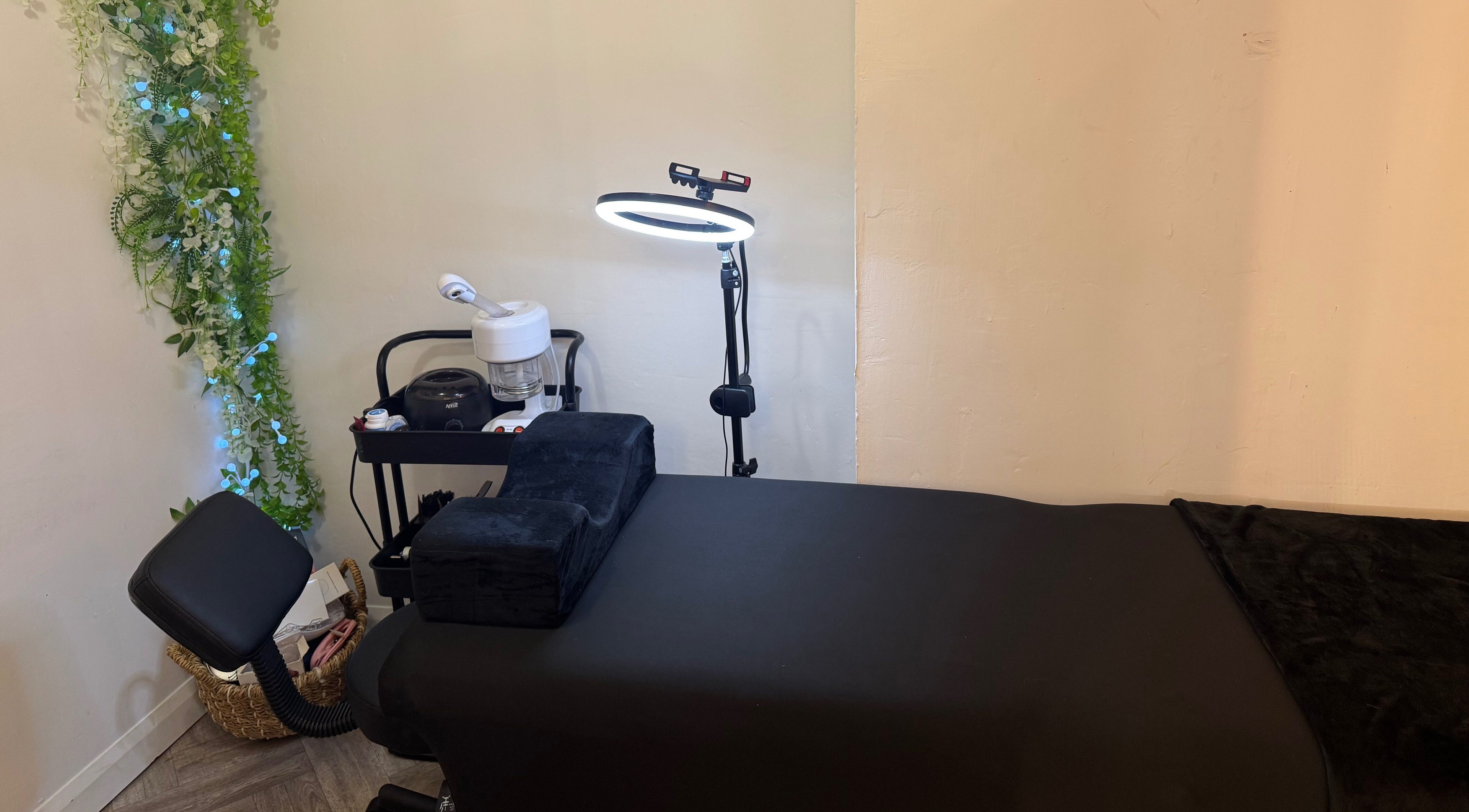 Relaxing treatment room at By Alicia - Hair and Beauty, Ponteland, England, GB with lush greenery decor.