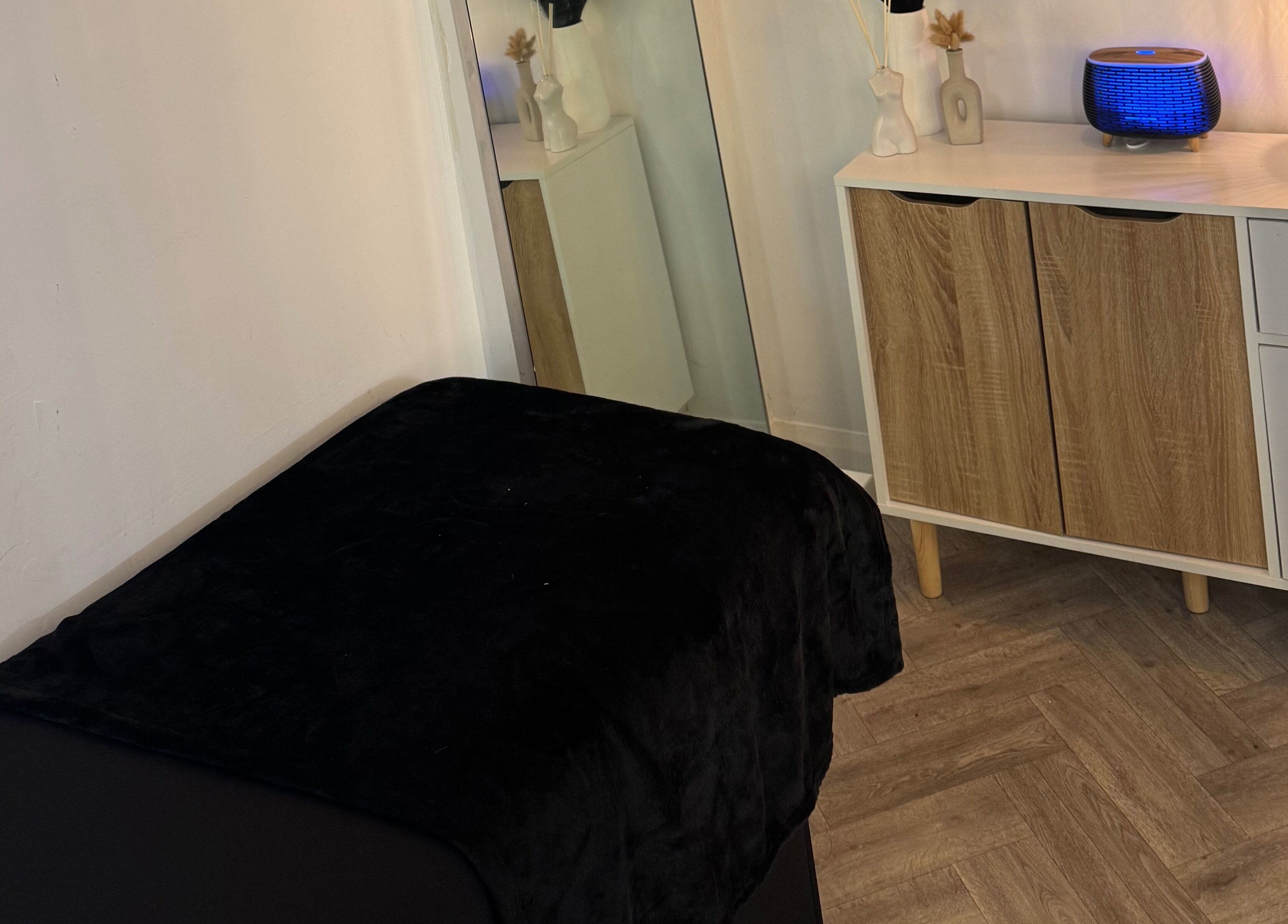 Relaxing spa room at By Alicia - Hair and Beauty, Ponteland, England, GB featuring a cozy massage bed.