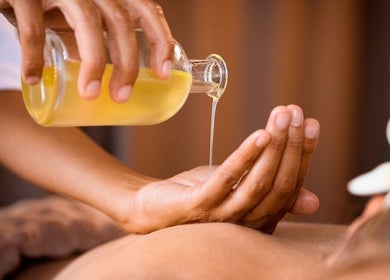 Massage oil poured at New You Massage in Roswell, Georgia, US for a soothing experience.