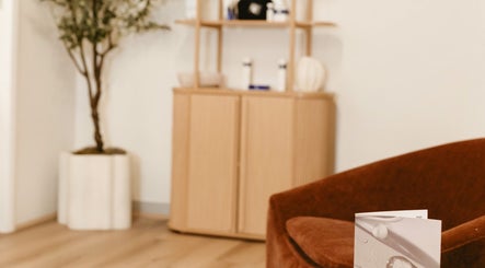 Cozy waiting area at Rejuve Aesthetica, Sydney, New South Wales, AU with a plush chair and modern decor.