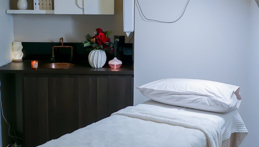 Elegant treatment room at Rejuve Aesthetica, Sydney, New South Wales, AU with massage bed and ambient decor.