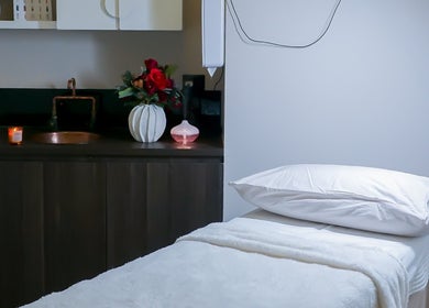 Elegant treatment room at Rejuve Aesthetica, Sydney, New South Wales, AU with massage bed and ambient decor.