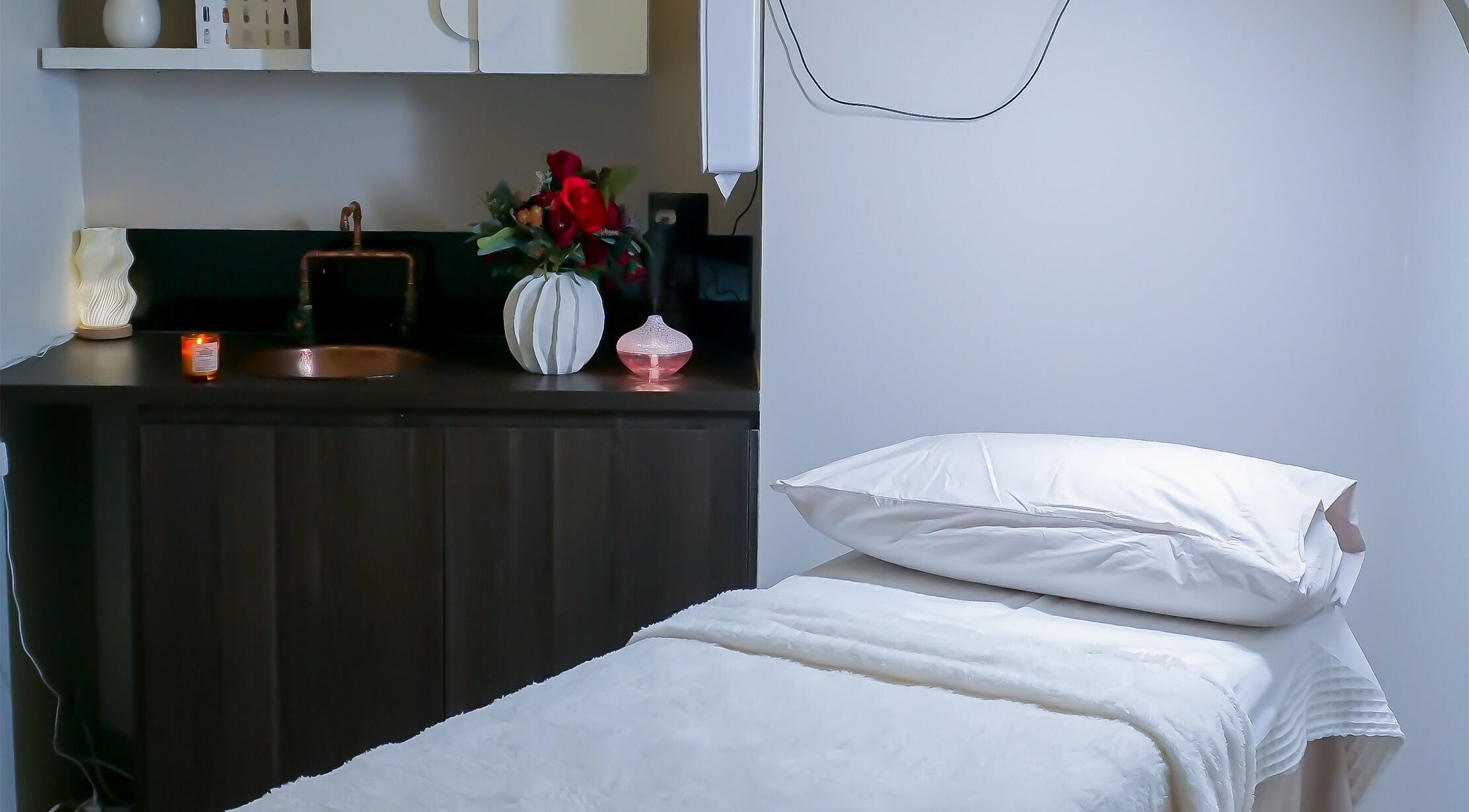 Elegant treatment room at Rejuve Aesthetica, Sydney, New South Wales, AU with massage bed and ambient decor.