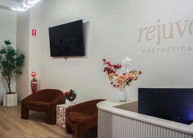 Reception area of Rejuve Aesthetica in Sydney, New South Wales, AU with chic decor and comfortable seating.