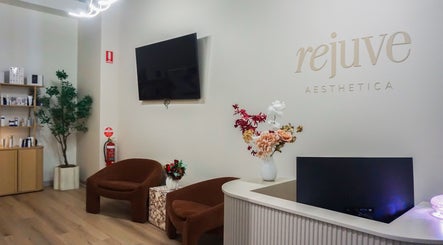 Reception area of Rejuve Aesthetica in Sydney, New South Wales, AU with chic decor and comfortable seating.