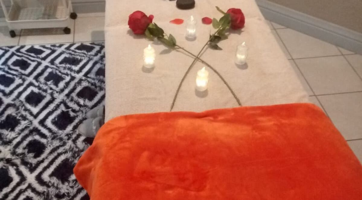 Relaxing spa setup with candles and rose petals at Magical Haven Spa, Johannesburg, Gauteng, ZA.