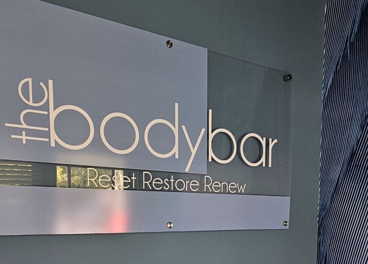 Elegant signage of The Body Bar in Gqeberha, Eastern Cape, ZA featuring the phrase 'Reset Restore Renew'.