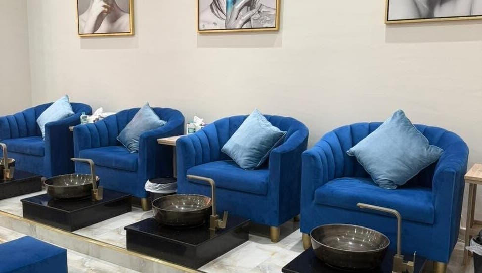 Luxurious blue velvet pedicure chairs at Queens Salon, Ajman, Ajman, AE. Ideal for a relaxing beauty experience.