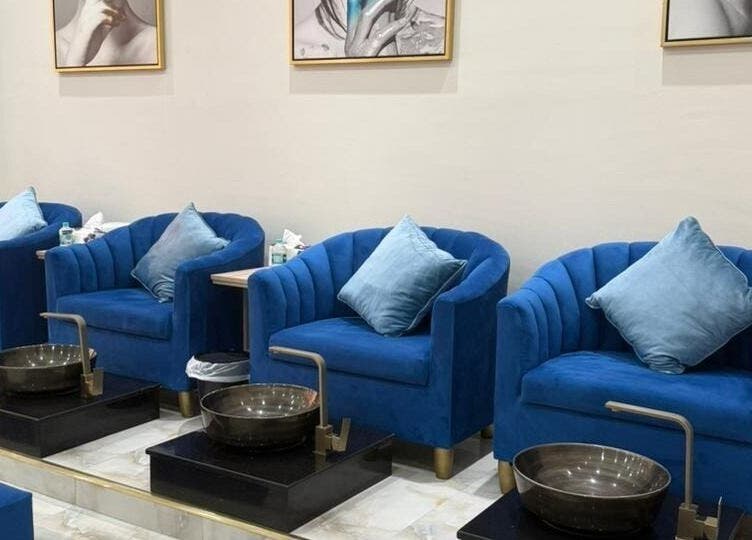 Luxurious blue velvet pedicure chairs at Queens Salon, Ajman, Ajman, AE. Ideal for a relaxing beauty experience.