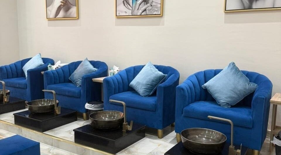 Luxurious blue velvet pedicure chairs at Queens Salon, Ajman, Ajman, AE. Ideal for a relaxing beauty experience.
