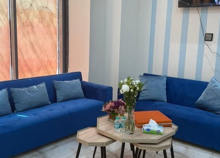 Inviting lounge with blue sofas at Queens Salon, Ajman, Ajman, AE. Perfect for relaxation before spa treatments.