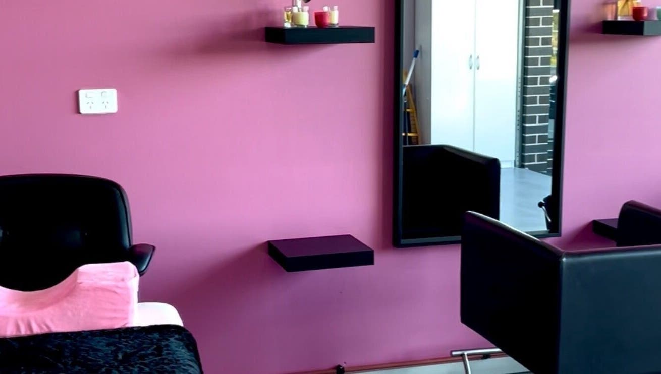 Chic Beauty Bar's stylish salon setup with pink walls and sleek furniture in Schofields, New South Wales, AU.
