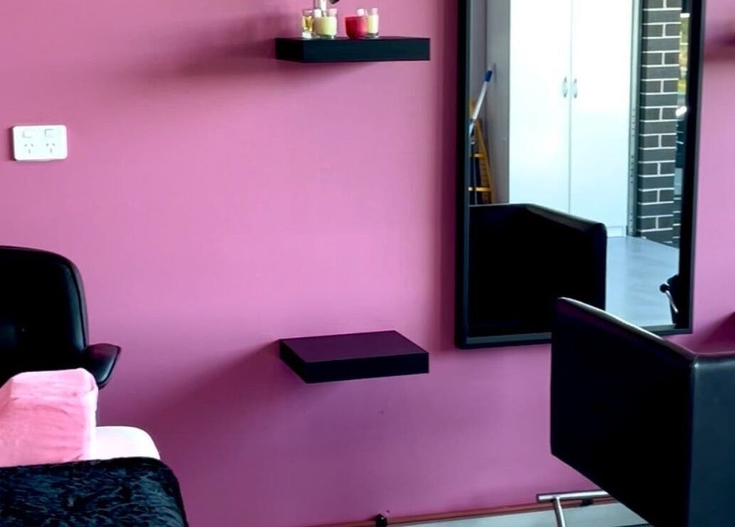 Chic Beauty Bar's stylish salon setup with pink walls and sleek furniture in Schofields, New South Wales, AU.