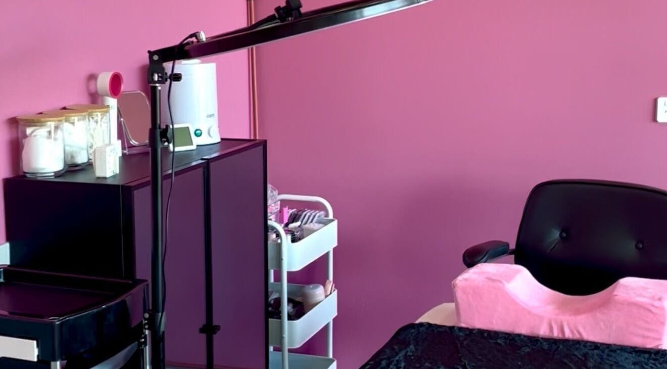 Chic Beauty Bar's cozy treatment room in Schofields, New South Wales, AU with a pink theme and equipment.