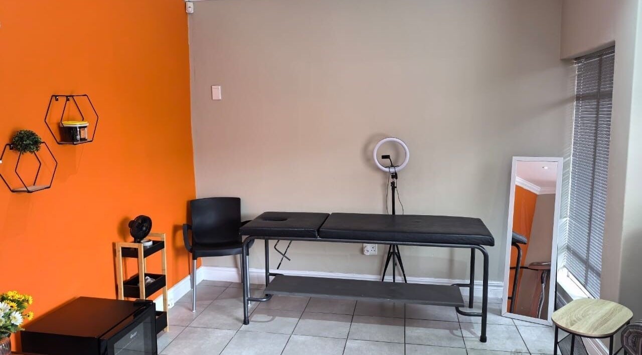 A therapy room at NASIMISA: Health & Wellness Hub in Pretoria features a massage table and serene decor.
