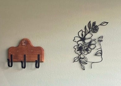 Chic floral wall art and wooden hooks at Tailored Nails & Lashes, Cape Town, Western Cape, ZA.