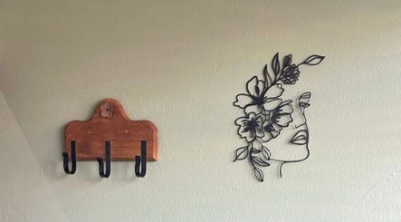 Chic floral wall art and wooden hooks at Tailored Nails & Lashes, Cape Town, Western Cape, ZA.