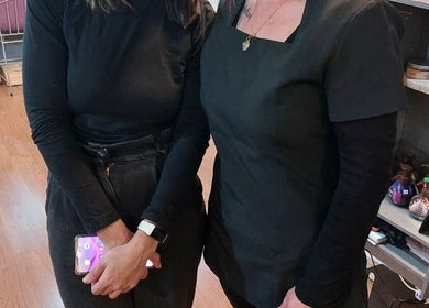 Two women at Tailored Nails & Lashes, Cape Town, Western Cape, ZA, standing in a warm, inviting salon setting.
