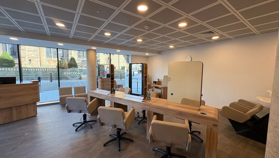 Modern salon interior at Saxons at Tamworth College, Tamworth, England, GB. Features stylish chairs and mirrors.