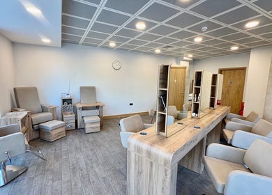 Modern beauty salon interior at Saxons at Tamworth College, Tamworth, England, GB, with stylish chairs.