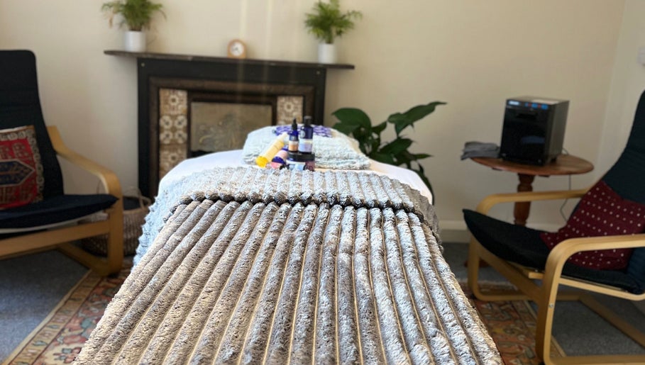 Relaxing therapy room at Her Sanctuary Holistic Therapies in Leeds, England, GB, featuring a cozy massage setup.