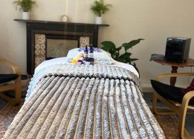 Relaxing therapy room at Her Sanctuary Holistic Therapies in Leeds, England, GB, featuring a cozy massage setup.