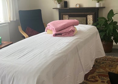 Cozy therapy room at Her Sanctuary Holistic Therapies, Leeds, England, GB with massage table and soothing decor.