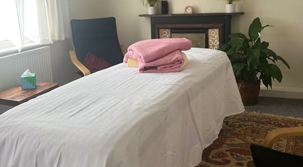 Cozy therapy room at Her Sanctuary Holistic Therapies, Leeds, England, GB with massage table and soothing decor.