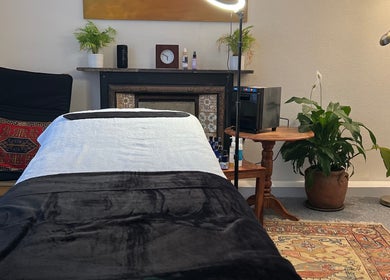Tranquil therapy room at Her Sanctuary Holistic Therapies, Leeds, England, GB with cozy decor and soft lighting.