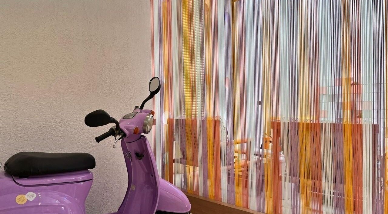 Purple scooter by colorful strings at Lapalma boutique, Riyadh, Riyadh Province, SA.