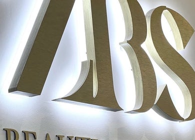Illuminated signage at Brows or Brows, London, England, GB highlighting beauty services.
