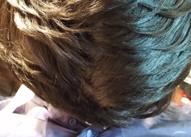 Top view of styled hair at Jae's Bare Bar, Ridgeland, Mississippi, US, showcasing sleek hair design.