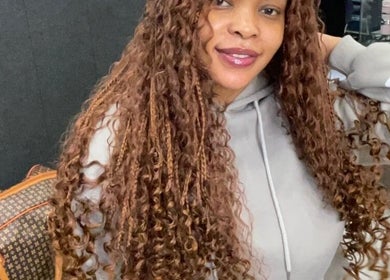 Woman flaunting luxurious curls at Lavish Looks Hair Studio, Cape Town, Western Cape, ZA.