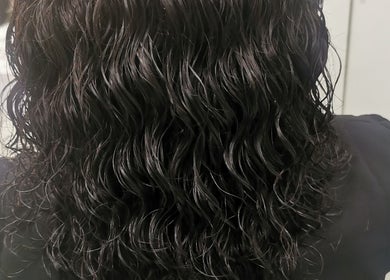 Glossy black curls styled at Lavish Looks Hair Studio, Cape Town, Western Cape, ZA for a fresh look.
