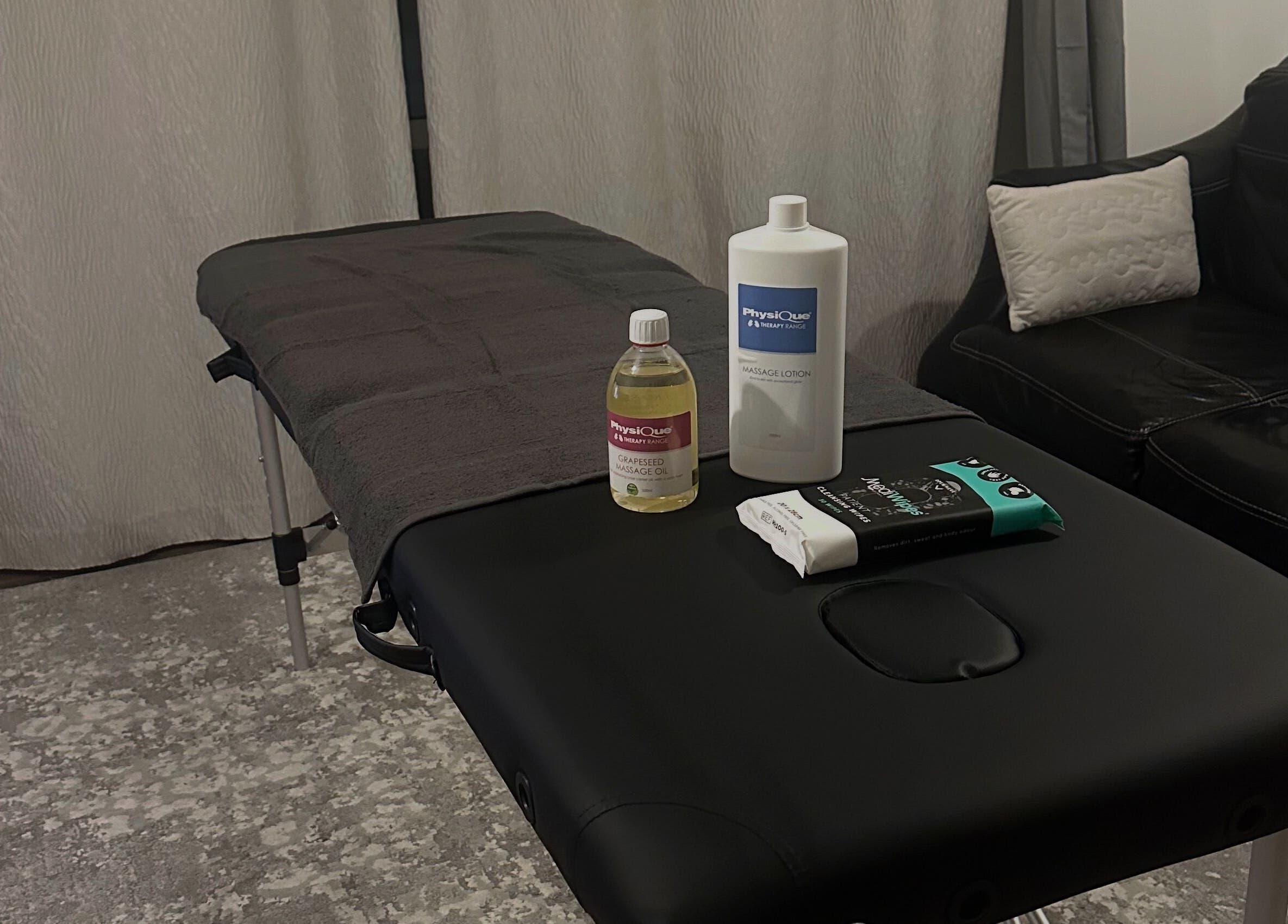 Massage table setup at ELEVATE Performance Sports Massage, Penarth, GB with oils and lotions.