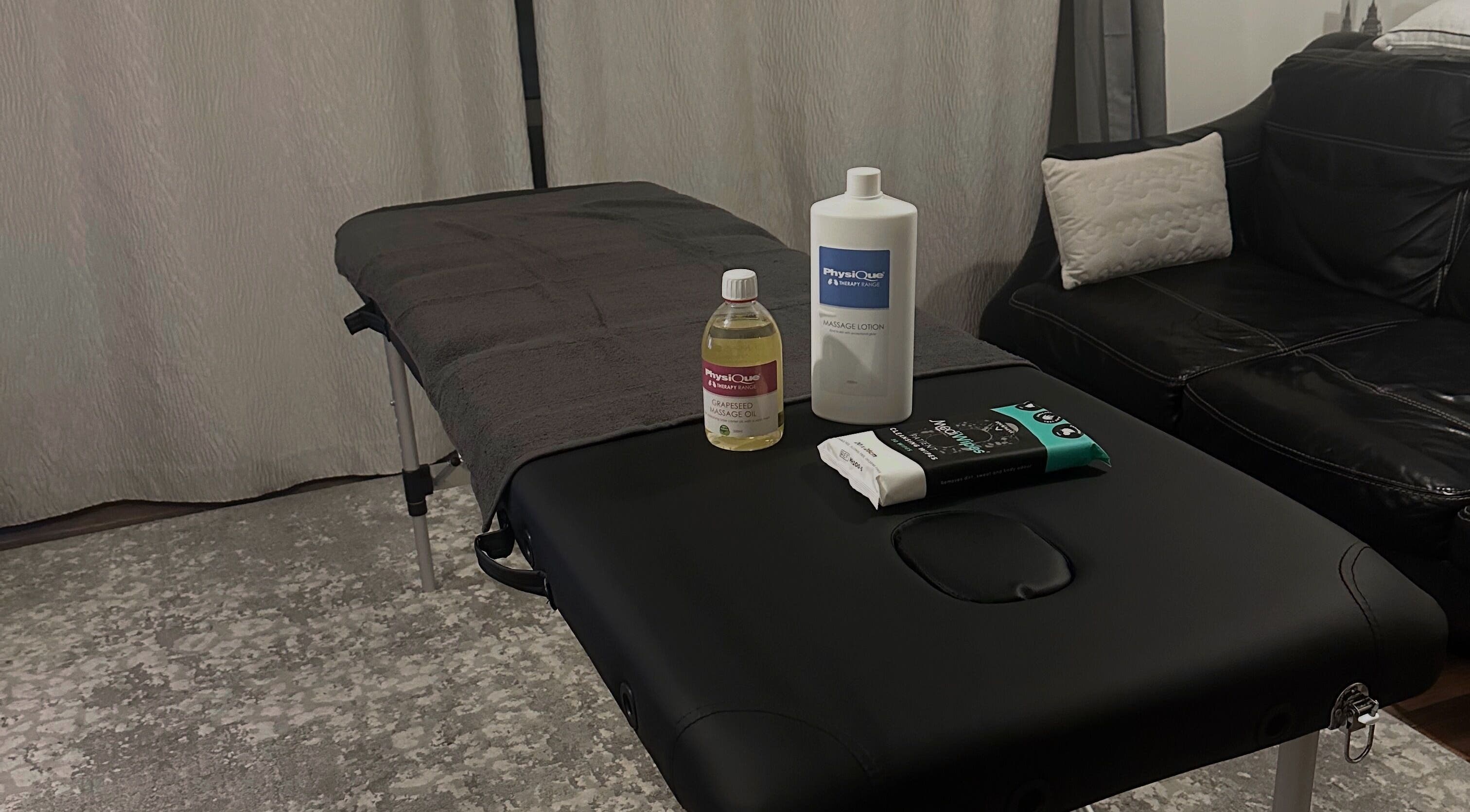 Massage table setup at ELEVATE Performance Sports Massage, Penarth, GB with oils and lotions.