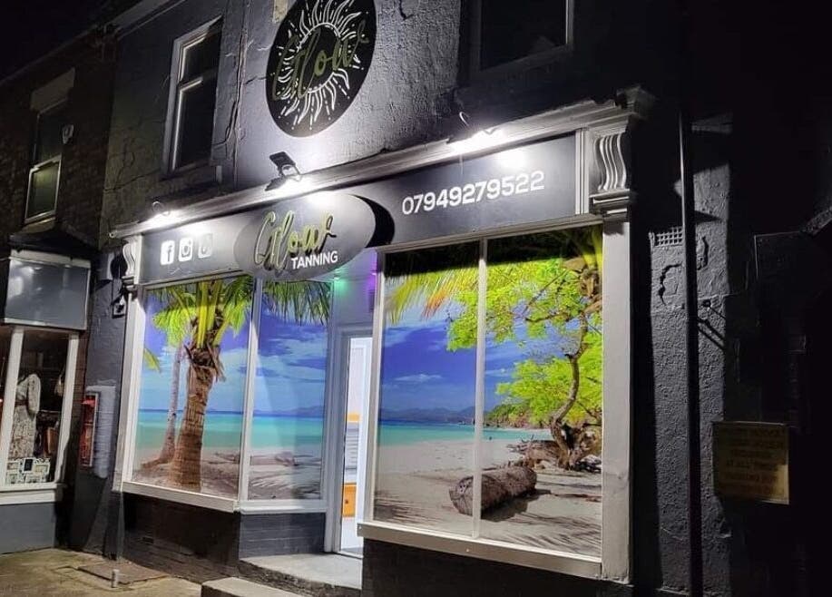 Vibrant tropical display at Beautybydarc, Sheffield, England, GB, beautifully illuminated at night.