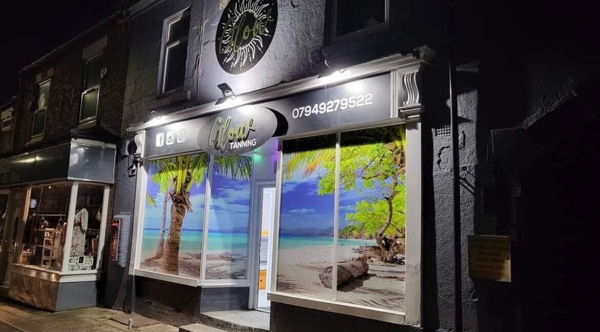 Vibrant tropical display at Beautybydarc, Sheffield, England, GB, beautifully illuminated at night.
