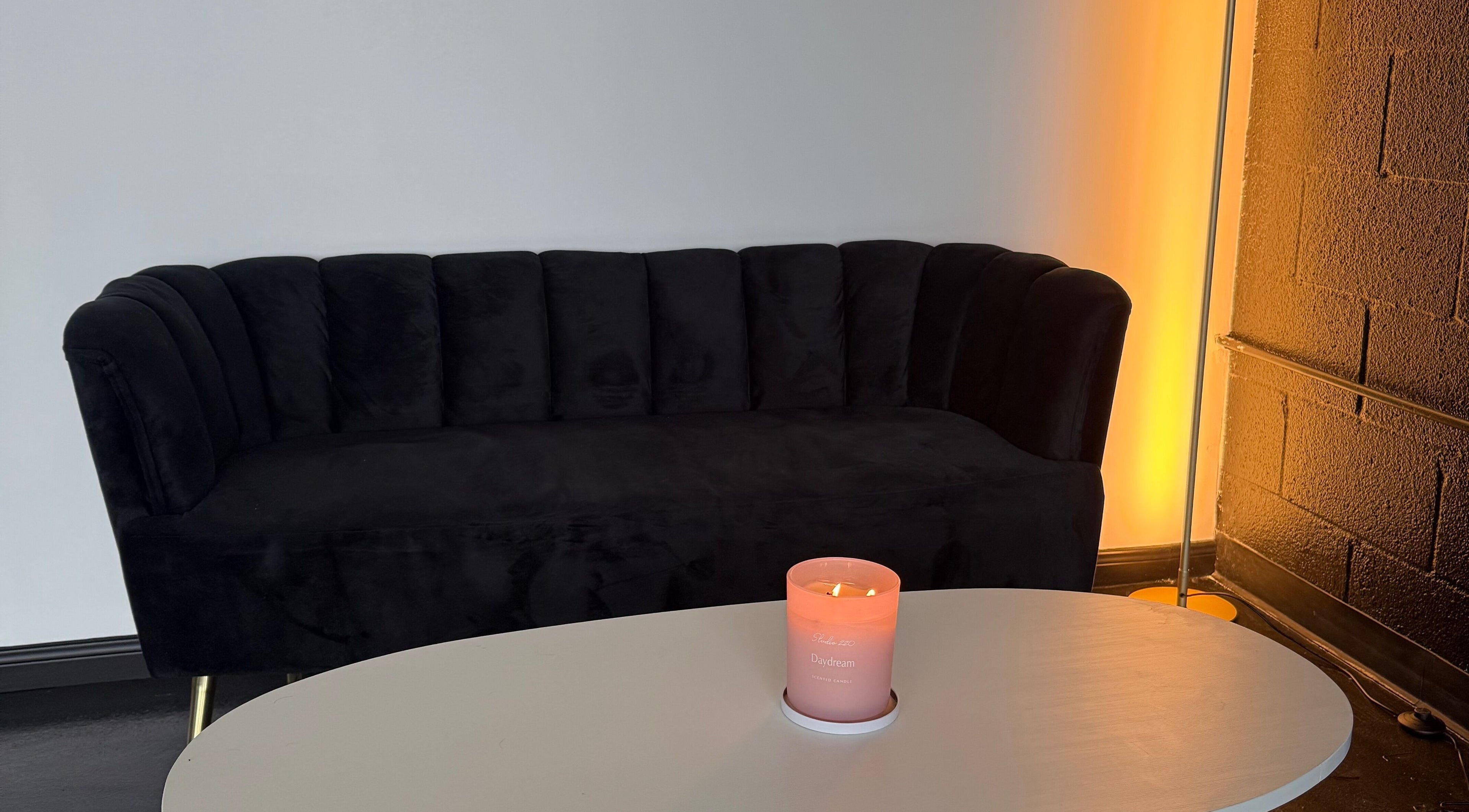 Cozy seating area with a lit candle at Vivaa Lá Beauty in Fort Worth, Texas, US.