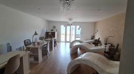 Chic interior of Nails by Claire, Par, England, GB with modern nail stations and cozy seating.