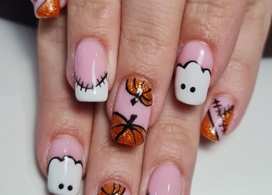 Halloween-themed nail art at Nails by Claire, Par, England, GB. Features pumpkins and ghosts on pastel nails.