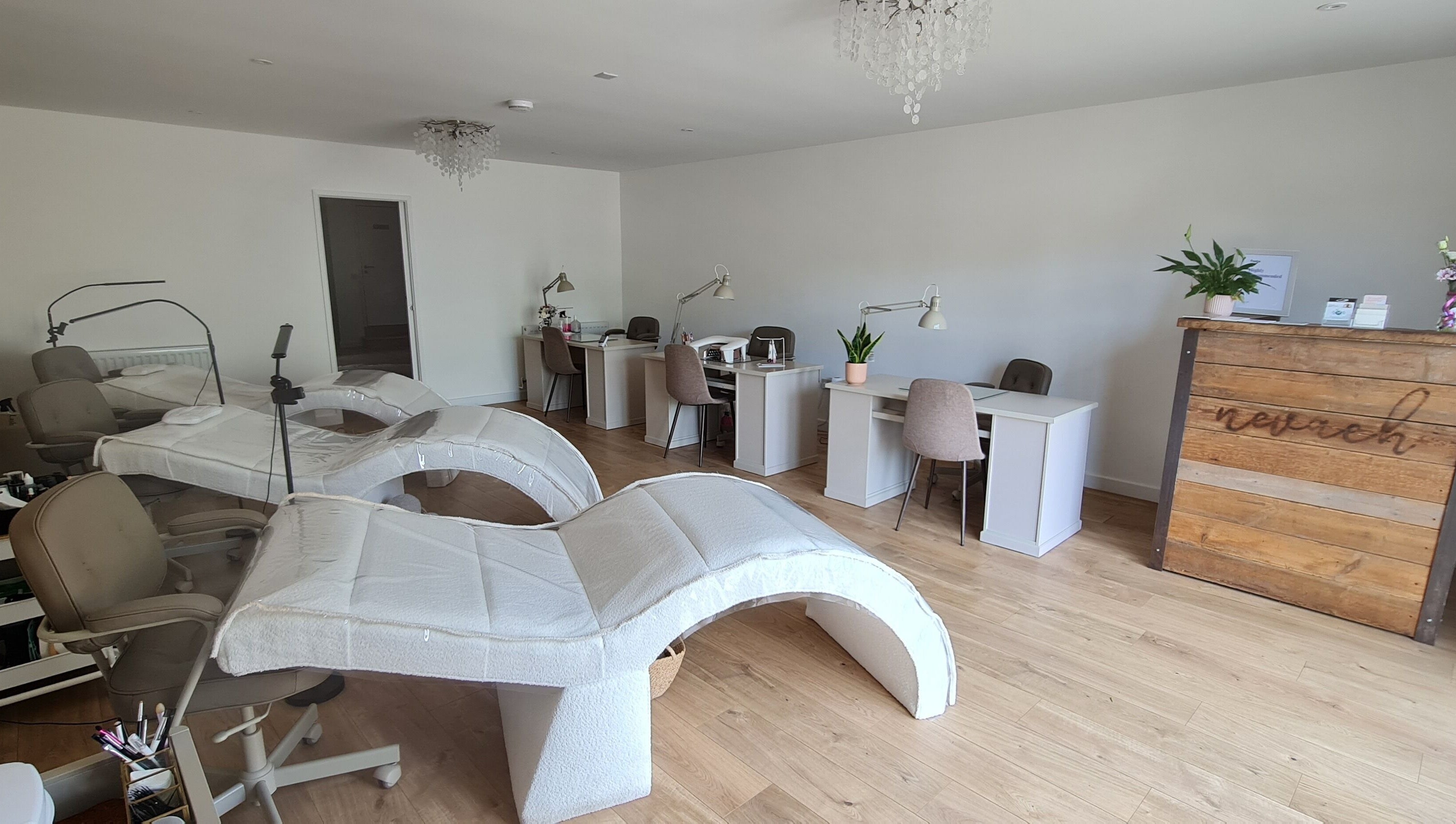 Spacious interior of Nails by Claire, Par, England, GB featuring nail stations and modern decor.