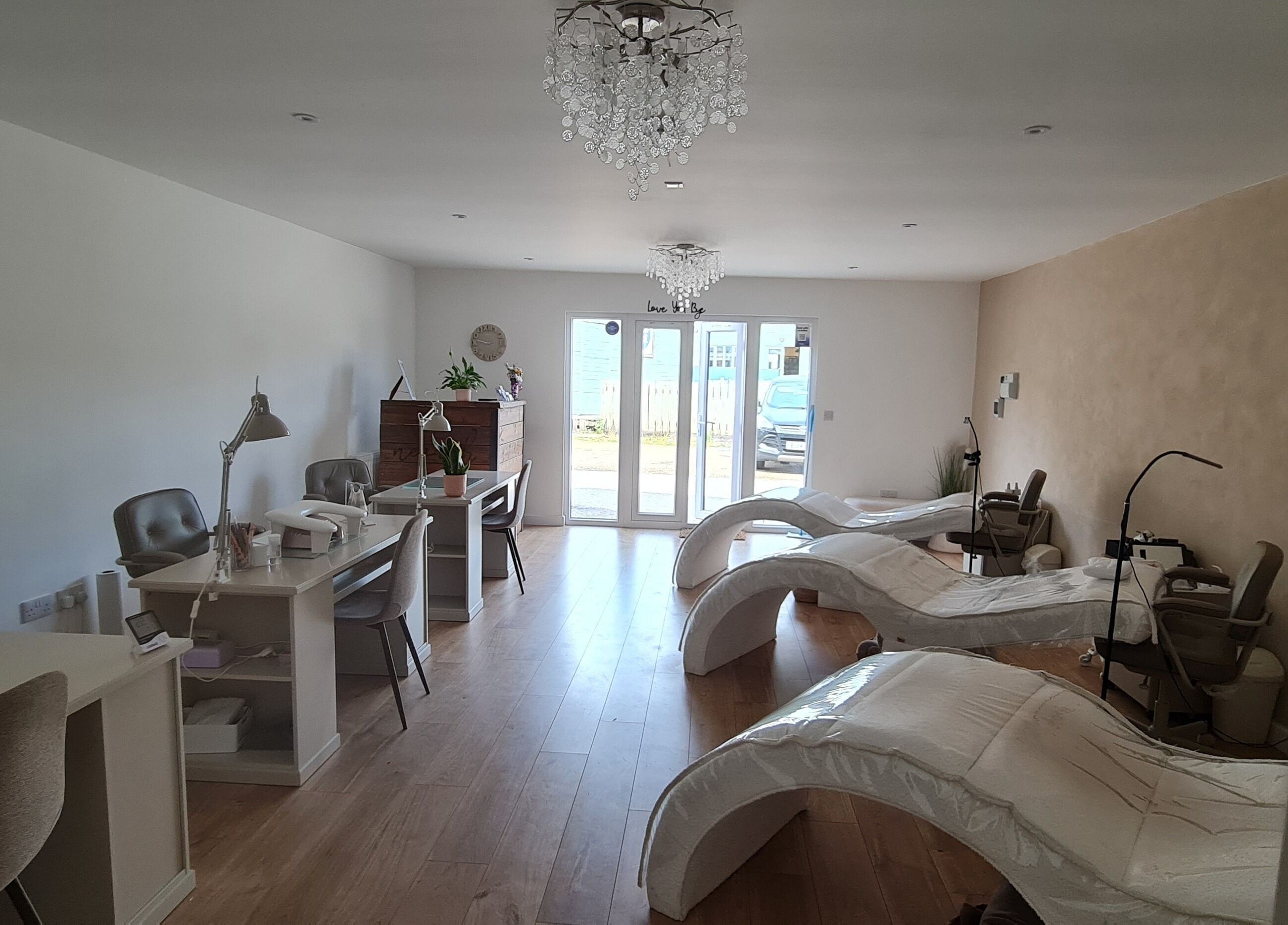 Luxurious interior of Nails by Claire, Par, England, featuring modern nail stations and plush chairs.