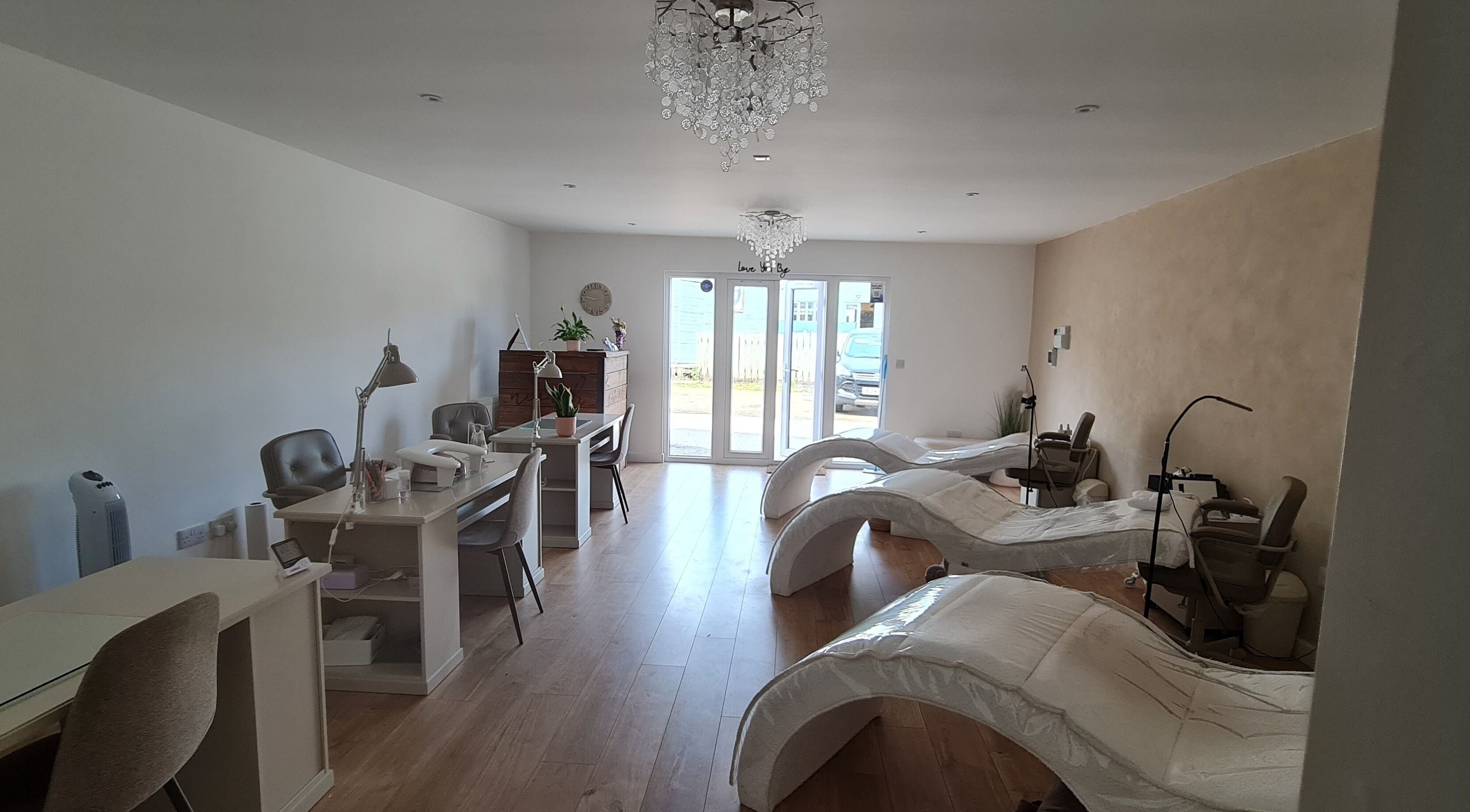 Luxurious interior of Nails by Claire, Par, England, featuring modern nail stations and plush chairs.