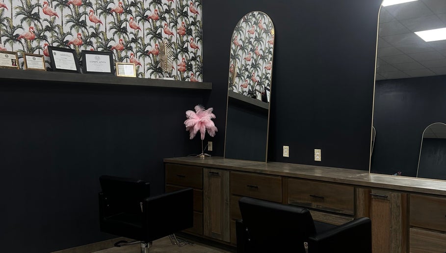 Chic interior of SG Stylez Hair Salon, Wills Point, Texas, with flamingo wallpaper and stylish mirrors.