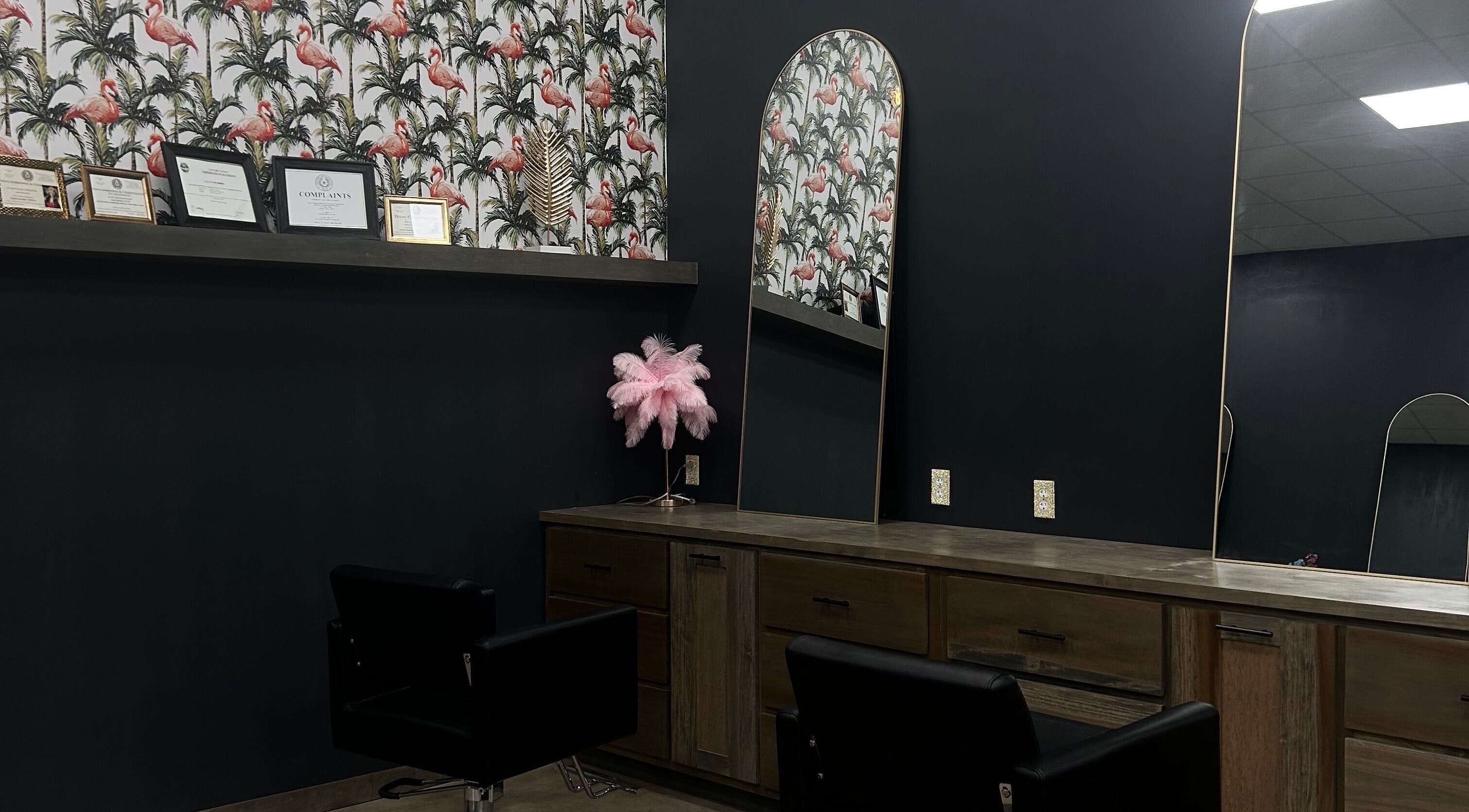 Chic interior of SG Stylez Hair Salon, Wills Point, Texas, with flamingo wallpaper and stylish mirrors.