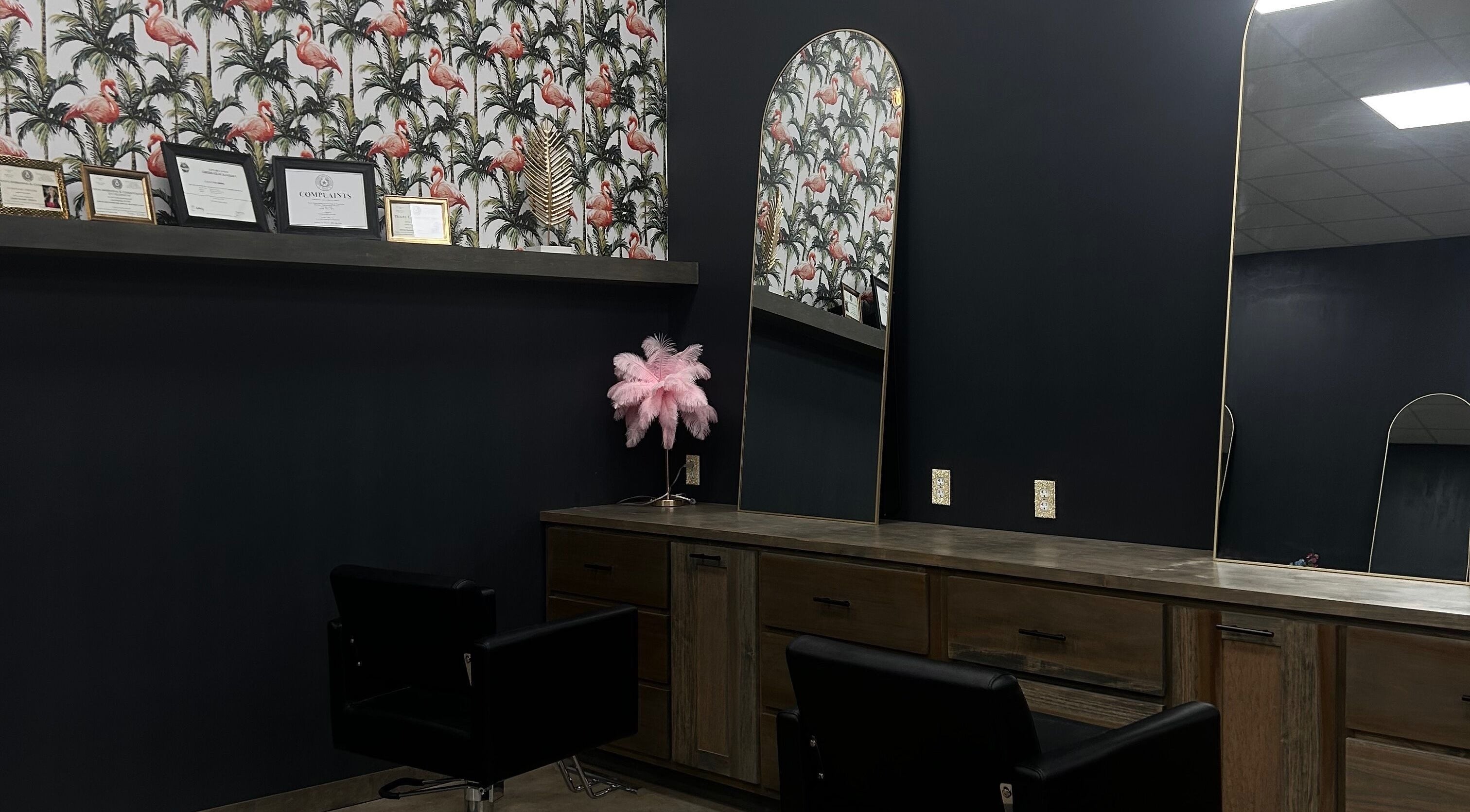 Chic interior of SG Stylez Hair Salon, Wills Point, Texas, with flamingo wallpaper and stylish mirrors.