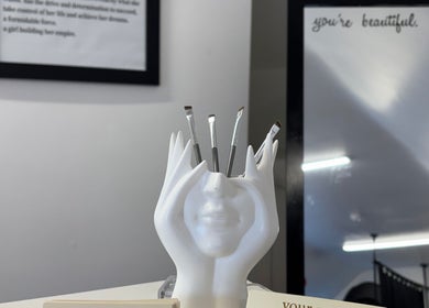 By Chloe Beauty in Ballina, County Mayo, IE showcases a unique face-shaped brush holder in a stylish interior.