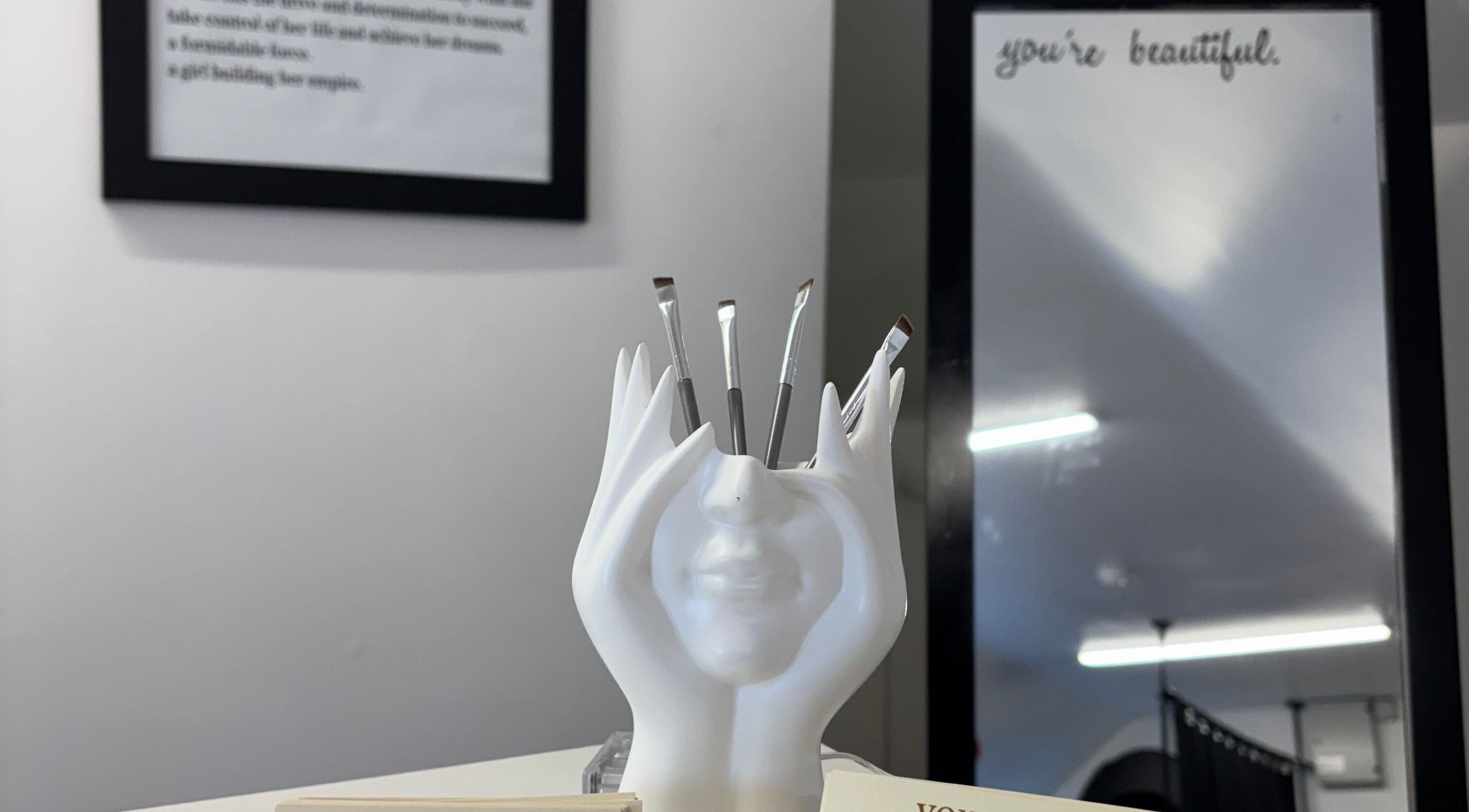 By Chloe Beauty in Ballina, County Mayo, IE showcases a unique face-shaped brush holder in a stylish interior.
